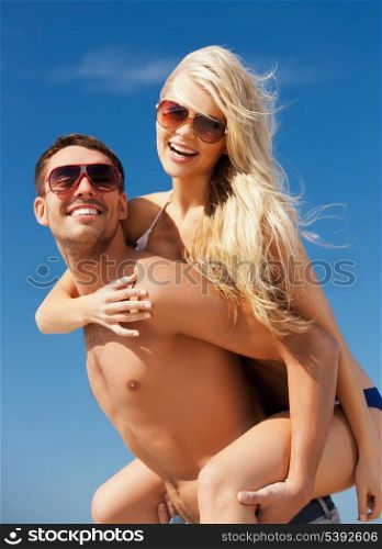 picture of happy couple in sunglasses on the beach.