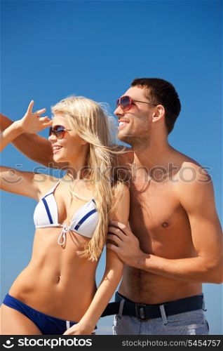 picture of happy couple in sunglasses on the beach.