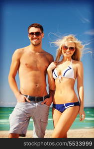 picture of happy couple in sunglasses on the beach