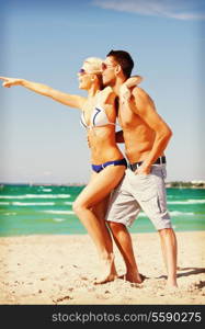 picture of happy couple in sunglasses on the beach