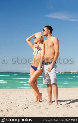 picture of happy couple in sunglasses on the beach (focus on woman)