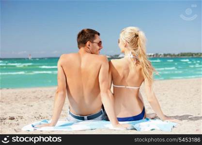 picture of happy couple sitting on the beach.