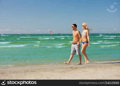 picture of happy couple walking on the beach.