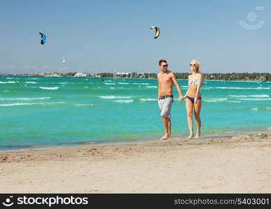 picture of happy couple walking on the beach.