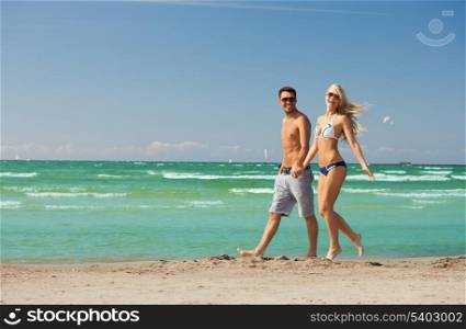 picture of happy couple walking on the beach.