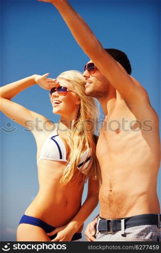 picture of happy couple walking on the beach (focus on man)