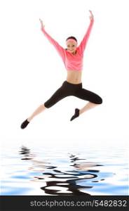 picture of happy girl jumping over water