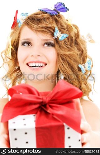 picture of happy girl with gift and butterflies over white