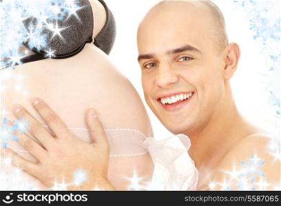 picture of happy man holding belly of pregnant woman