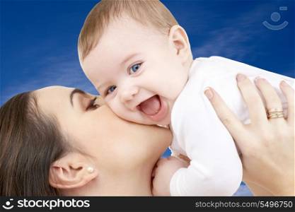 picture of happy mother with baby boy over blue sky