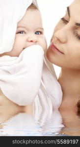 picture of happy mother with baby in water (focus on mother)