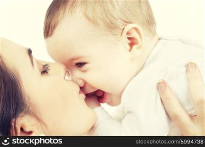 picture of happy mother with baby over white. happy mother kissing baby boy