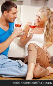 picture of happy romantic couple drinking wine (focus on woman)