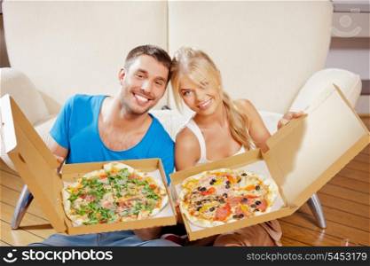 picture of happy romantic couple eating pizza at home