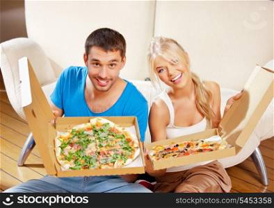 picture of happy romantic couple eating pizza at home