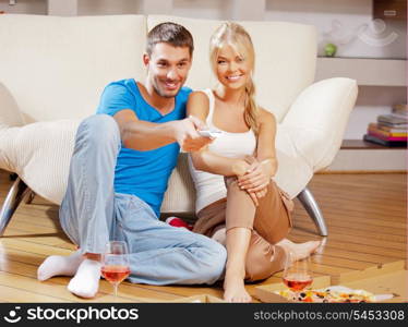 picture of happy romantic couple with remote
