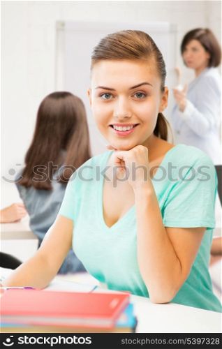 picture of happy smiling student girl with books at school