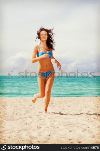 picture of happy smiling woman jogging on the beach