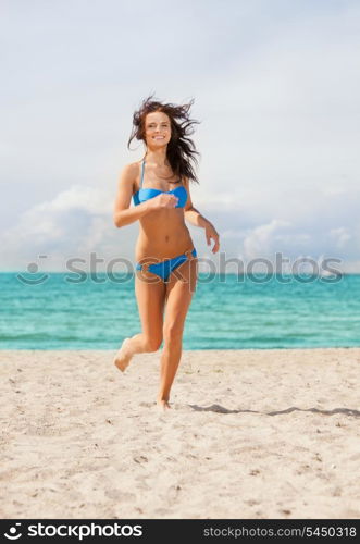 picture of happy smiling woman jogging on the beach.