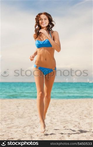 picture of happy smiling woman jogging on the beach.