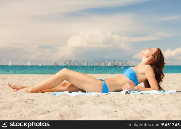 picture of happy smiling woman laying on a towel