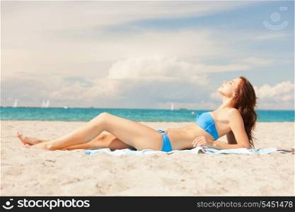picture of happy smiling woman laying on a towel
