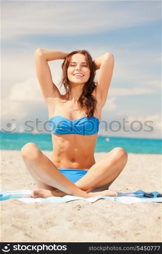 picture of happy smiling woman sitting on a towel.