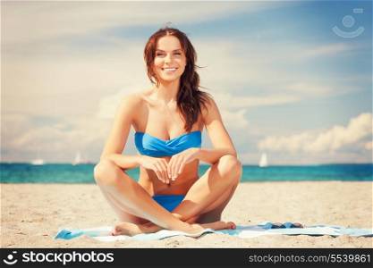 picture of happy smiling woman sitting on a towel