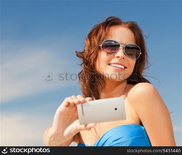 picture of happy smiling woman using phone camera .