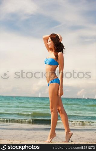 picture of happy smiling woman walking on the beach.