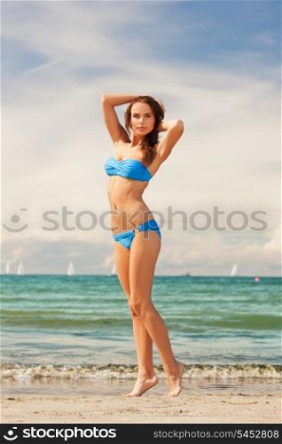 picture of happy smiling woman walking on the beach.
