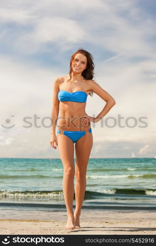 picture of happy smiling woman walking on the beach.