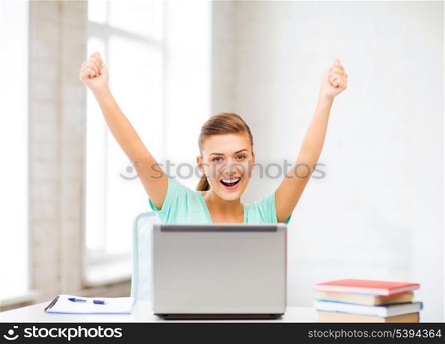 picture of happy student girl with laptop at school