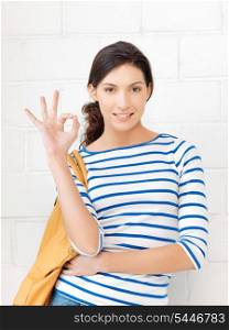 picture of happy teenage girl showing ok sign