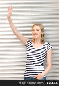 picture of happy teenage girl waving a greeting