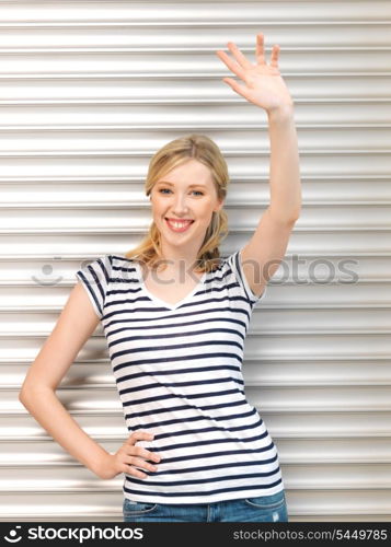 picture of happy teenage girl waving a greeting