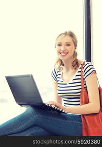 picture of happy teenage girl with laptop computer. happy teenage girl with laptop computer