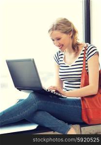 picture of happy teenage girl with laptop computer. happy teenage girl with laptop computer