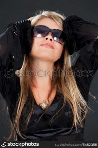 picture of happy woman in shades over black