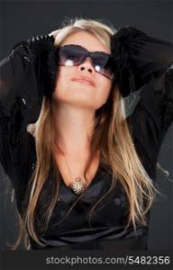 picture of happy woman in shades over black