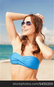 picture of happy woman in sunglasses on the beach.