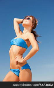 picture of happy woman in sunglasses on the beach.