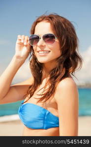 picture of happy woman in sunglasses on the beach.