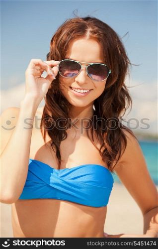picture of happy woman in sunglasses on the beach.