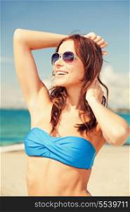 picture of happy woman in sunglasses on the beach