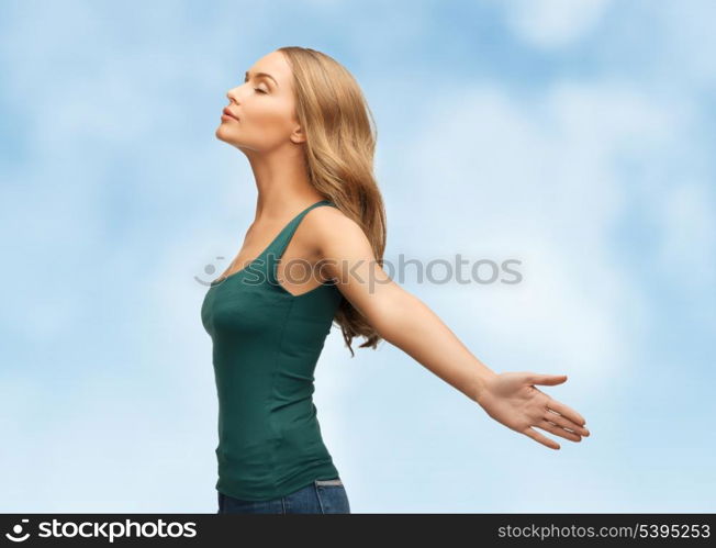 picture of happy woman spreading hands over blue sky.