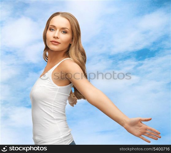 picture of happy woman spreading hands over blue sky.