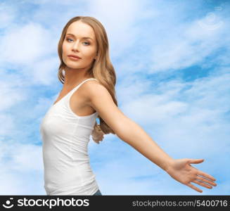 picture of happy woman spreading hands over blue sky.