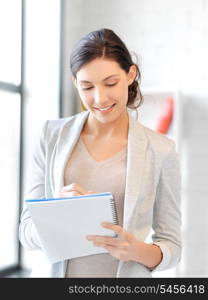 picture of happy woman with big notepad