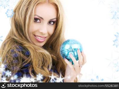picture of happy woman with blue christmas ball